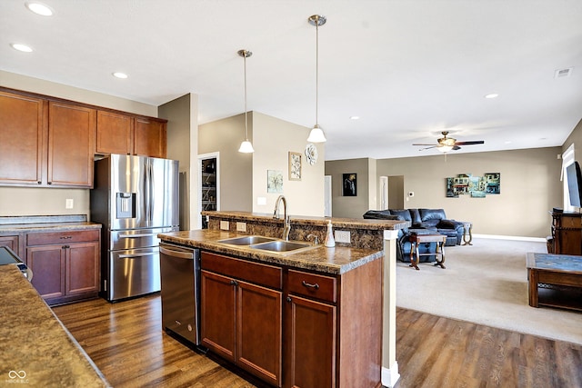 kitchen with pendant lighting, sink, dark wood-type flooring, ceiling fan, and appliances with stainless steel finishes