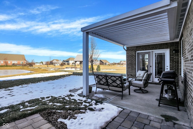 snow covered patio featuring an outdoor hangout area and grilling area