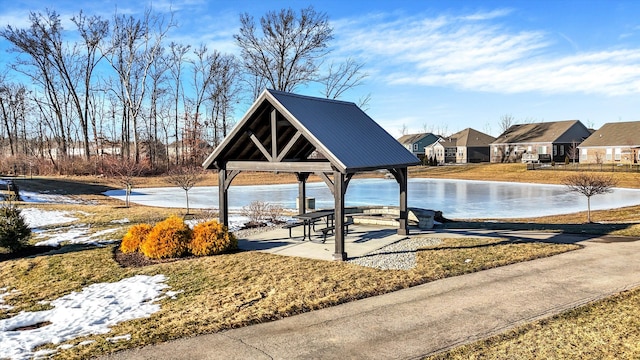 view of swimming pool featuring a gazebo, a lawn, and a water view