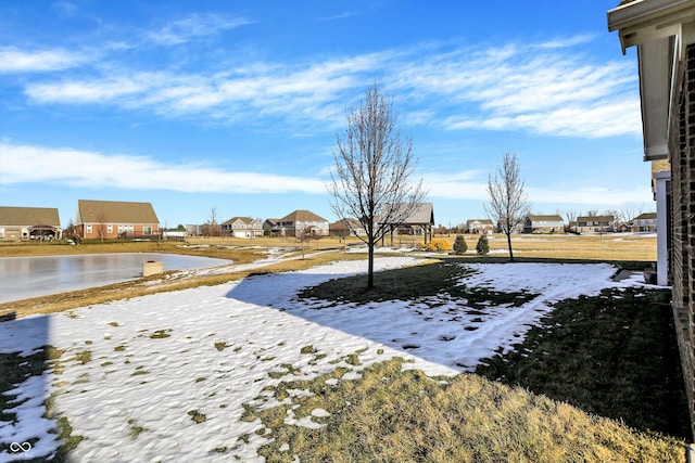 snowy yard featuring a water view