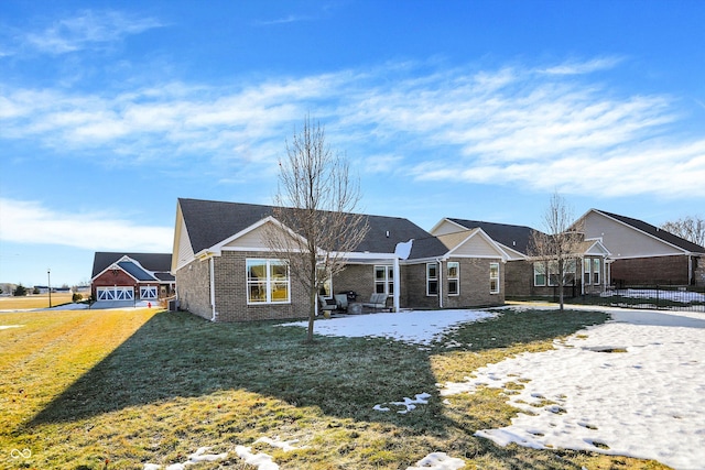 rear view of house featuring a lawn