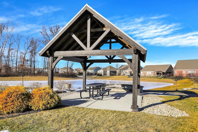 view of community with a yard, a gazebo, and a water view