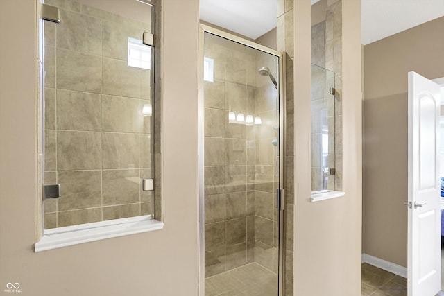 bathroom featuring a shower with door