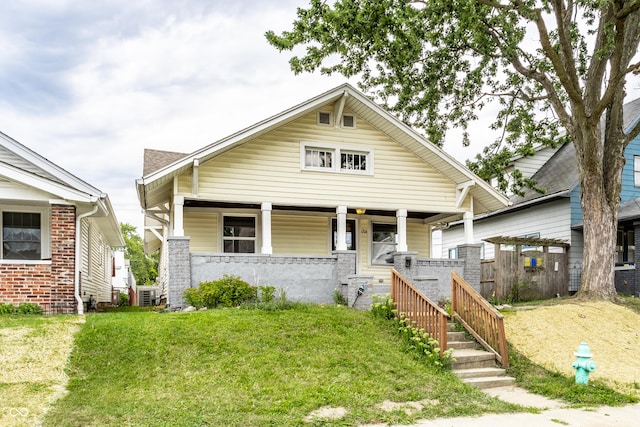 bungalow featuring a front yard and covered porch