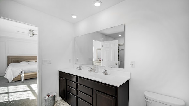 bathroom with vanity, ceiling fan, and toilet