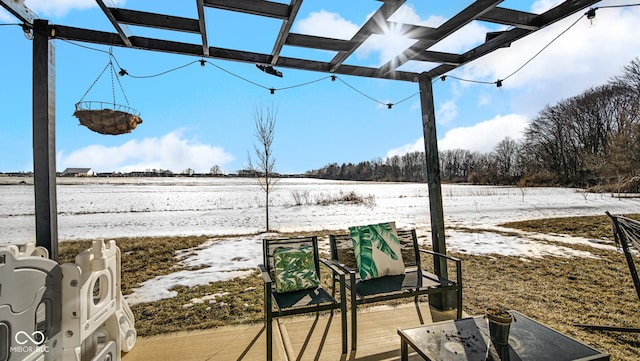 snow covered deck featuring a pergola