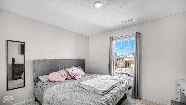 bedroom featuring light carpet