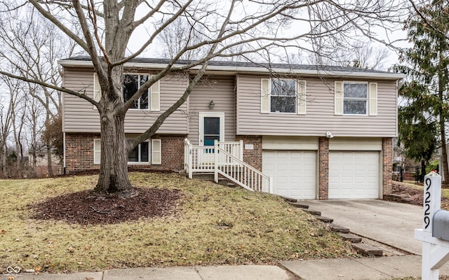 bi-level home with concrete driveway, an attached garage, and brick siding