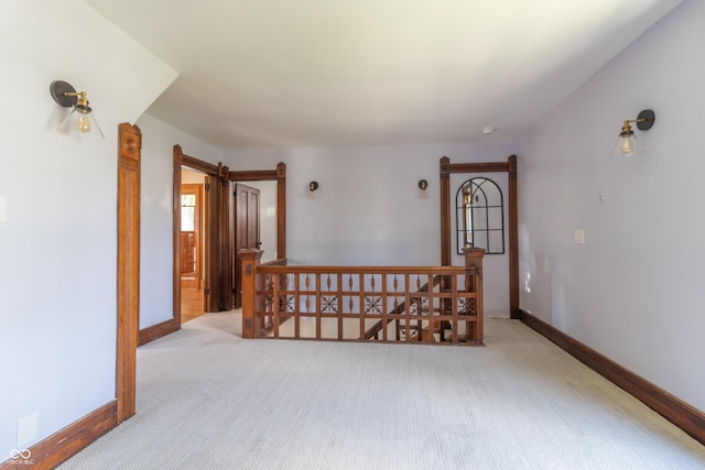 empty room with light carpet and a barn door