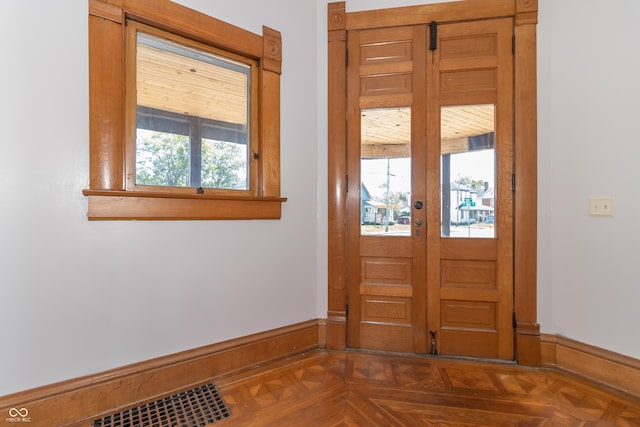 foyer with dark parquet floors