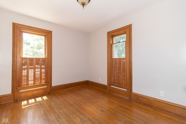 spare room with wood-type flooring