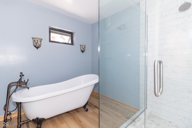 bathroom featuring shower with separate bathtub and hardwood / wood-style floors