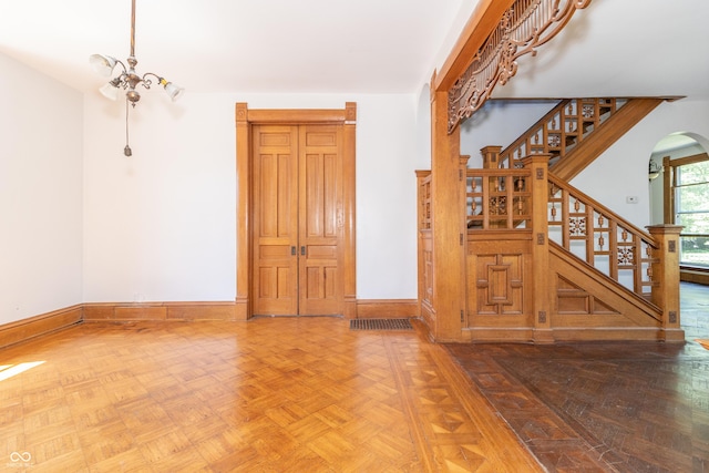 interior space with an inviting chandelier and parquet flooring