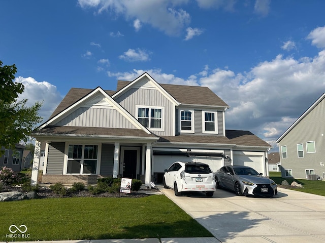 9426 Orchard Cove Dr, Indianapolis, IN 46239 - view of front of home with concrete driveway, board and batten siding, and a front lawn