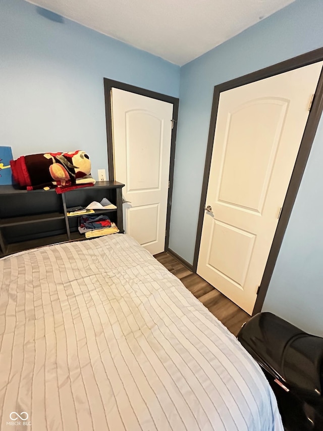 bedroom featuring dark hardwood / wood-style flooring