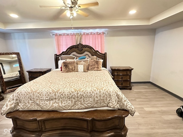 bedroom featuring ceiling fan and light hardwood / wood-style flooring