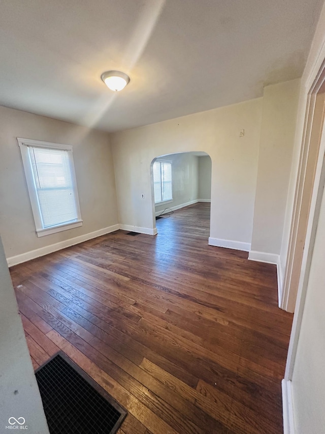 empty room featuring dark wood-type flooring