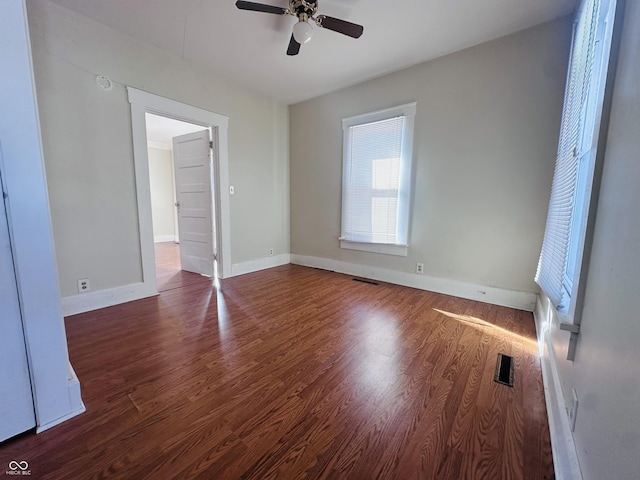 spare room featuring ceiling fan and dark hardwood / wood-style floors