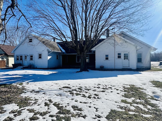 view of snow covered rear of property