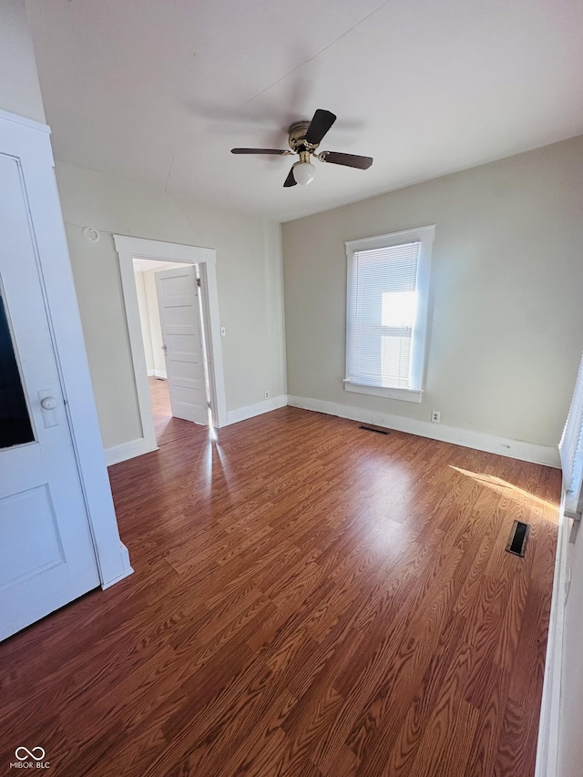 empty room with hardwood / wood-style floors and ceiling fan