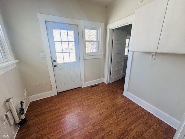 doorway with dark wood-type flooring