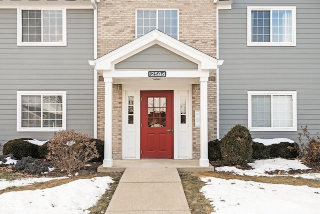 view of snow covered property entrance