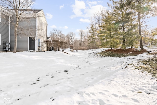 yard layered in snow with a garage