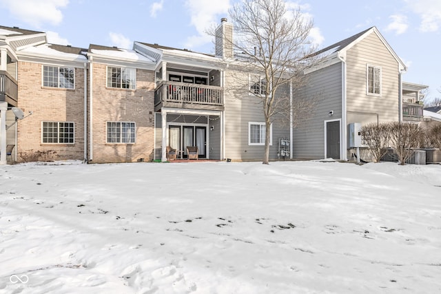 snow covered house with a balcony