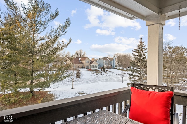 view of snow covered back of property