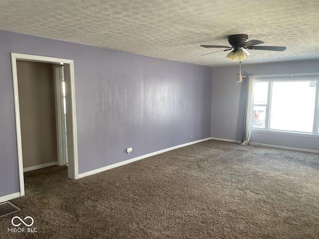 carpeted empty room featuring ceiling fan and a textured ceiling