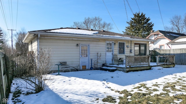 snow covered property featuring a wooden deck