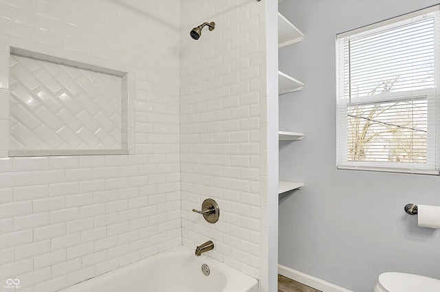 full bathroom featuring shower / bath combination, baseboards, and toilet