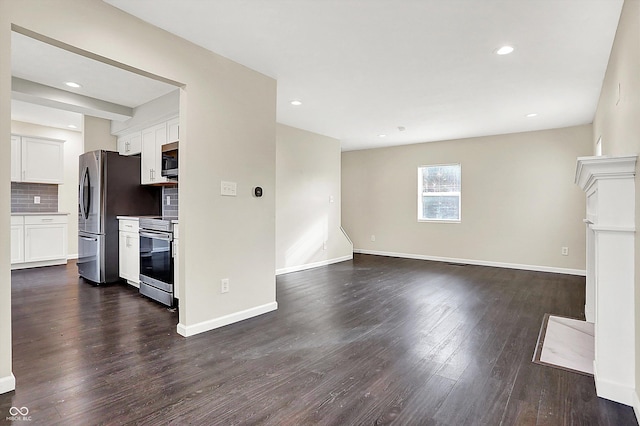 unfurnished living room featuring dark wood-type flooring, recessed lighting, and baseboards