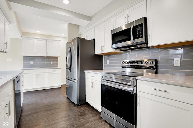 kitchen featuring stainless steel appliances, light countertops, dark wood finished floors, and white cabinetry