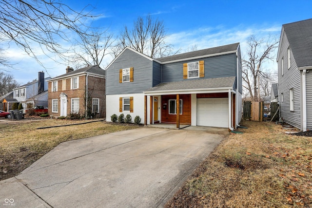 view of front of house with driveway, a garage, roof with shingles, fence, and a front lawn