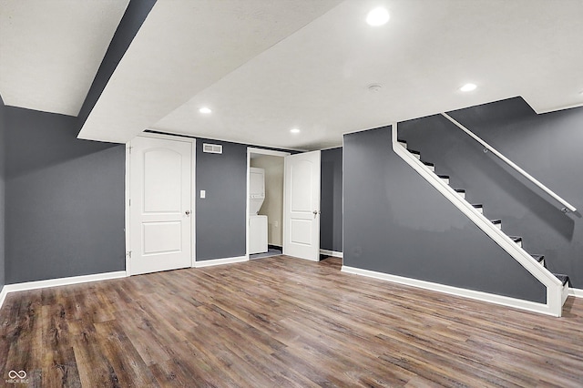 finished below grade area with baseboards, visible vents, stairway, wood finished floors, and recessed lighting