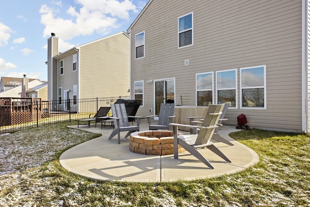 rear view of property with an outdoor fire pit and a patio