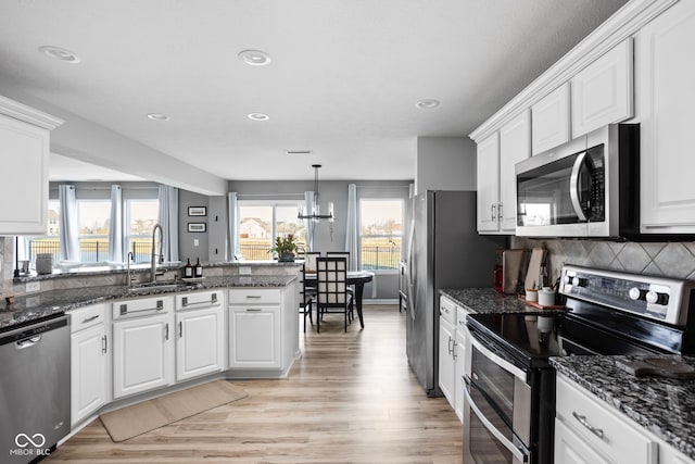 kitchen featuring stainless steel appliances and white cabinets