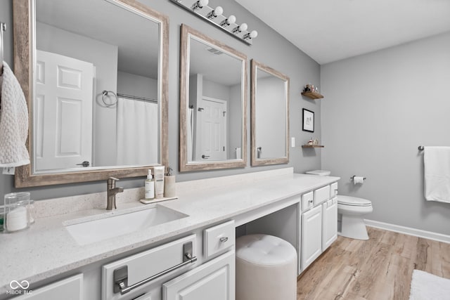 bathroom featuring vanity, toilet, a shower with shower curtain, and wood-type flooring