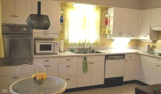 kitchen with oven, sink, and white cabinets