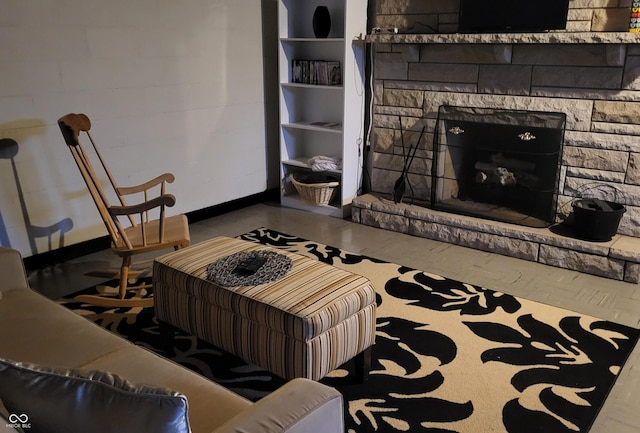 living room with a stone fireplace