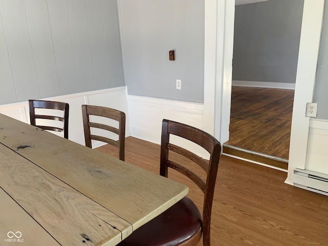 dining area featuring wood-type flooring and baseboard heating