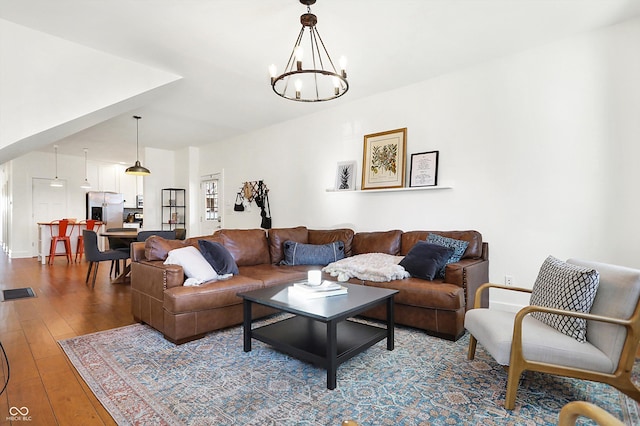 living room with an inviting chandelier and wood-type flooring