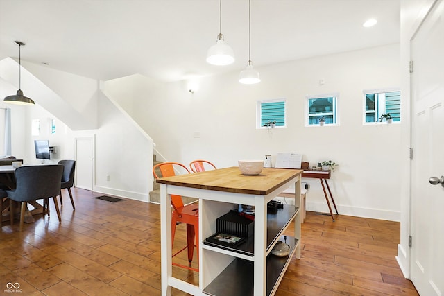 dining space with wood-type flooring