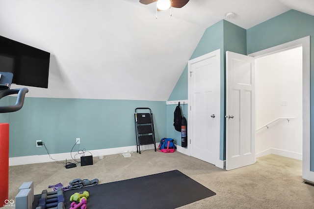 exercise area with ceiling fan, light colored carpet, and lofted ceiling