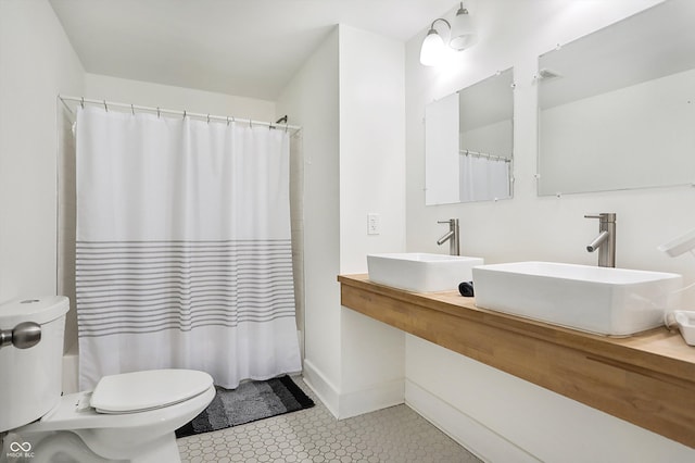 full bathroom with shower / tub combo, sink, and toilet