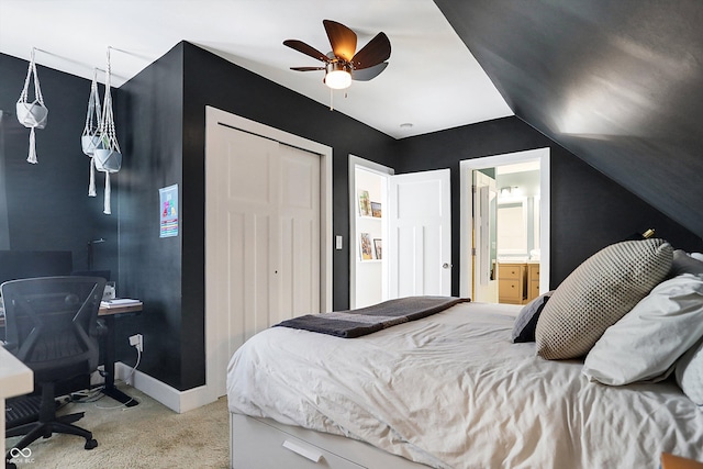 carpeted bedroom featuring ensuite bath, vaulted ceiling, a closet, and ceiling fan