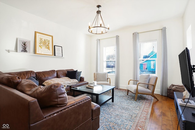 living room featuring hardwood / wood-style floors and an inviting chandelier