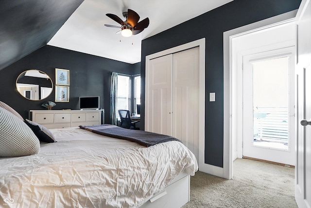 carpeted bedroom with lofted ceiling, a closet, and ceiling fan