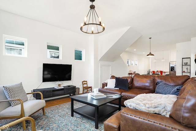 living room with wood-type flooring and a notable chandelier